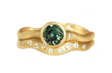 alternative engagement ring with green sapphires and diamond wedding band