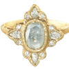 Oval raw diamond in a halo of diamonds, hammered gold ring