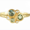 Green sapphires and diamonds textured gold ring