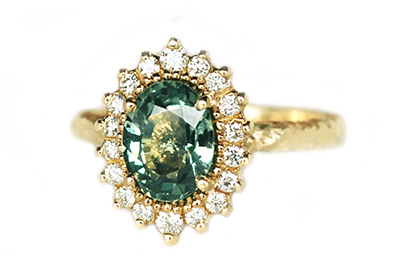 Alternative engagement ring with an oval Green Sapphire and diamonds