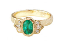 oval emerald ring with pear diamond accents, textured gold
