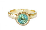 Artisanal hammered gold ring set with a large green Madagascar sapphire, made in Canada