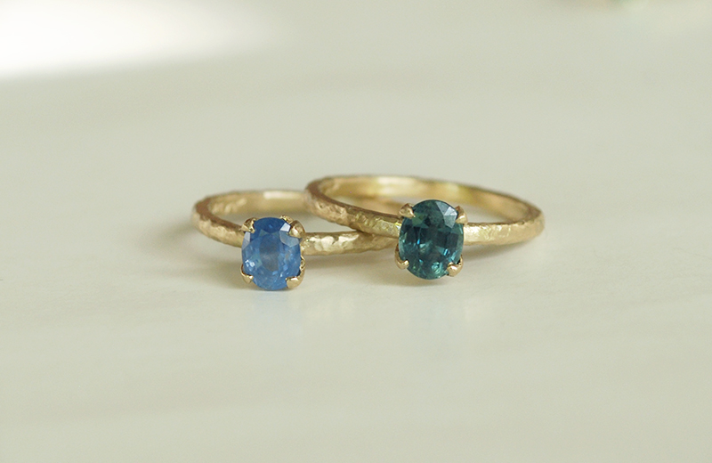 alternative engagement rings blue and teal oval sapphires, hammered gold