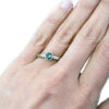 green sapphire solitaire hammered gold ring on hand in canada