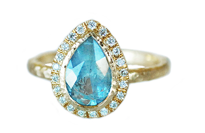 unique engagement ring with a teal sapphire pear halo of diamonds