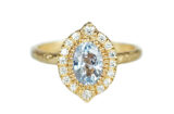 light blue sapphire set in a halo of accent diamonds, hammered gold artisanal ring