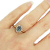 alternative engagement ring with teal sapphire and diamond halo