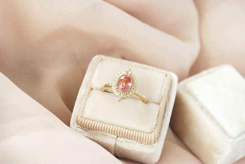 Peach padparadscha sapphire ring with diamond halo