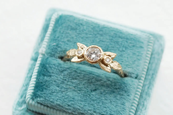 Gold leaf ring with round diamond and accent diamonds