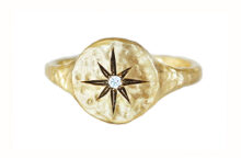 Hammered gold signet ring with a carved compass and a diamond
