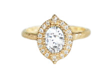 Oval diamond ring with a halo of small diamonds