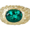 textured gold ring with large oval emerald