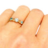 Three drops sapphire and diamond trinity ring on a hand