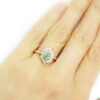 artisanal ring with icy diamond and oval halo of diamonds