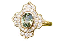 Reusing family diamonds in an ornate halo ring with an oval green sapphire