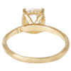 Organic gold ring with an oval old mine cut diamond set in prongs and a rant of accent diamonds