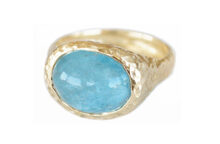 textured gold ring with an oval aquamarine cabochon