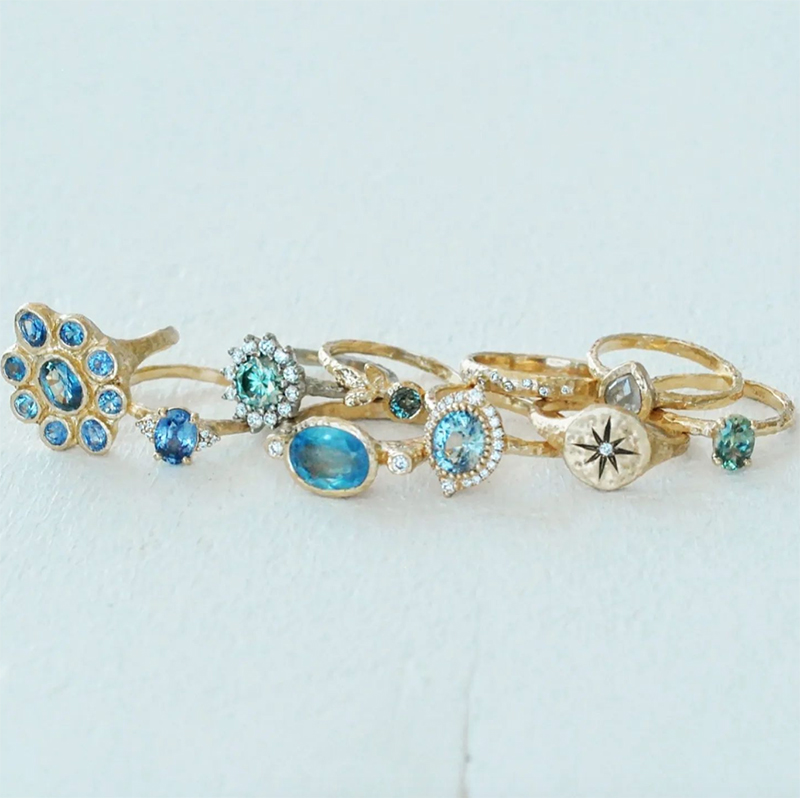 Grouping of artisanal gold rings with blue sapphires, aquamarines and diamonds
