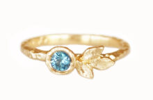 Three gold leaf ring with a teal sapphire