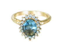 Light aqua sapphire vintage rosetta with a halo of accent diamonds