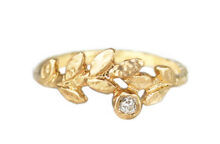 old mine cut diamond set among gold leaves in a hammered gold ring