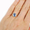 Light blue oval sapphire hammered gold ring on hand