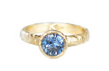 Light blue sapphire ring in hammered gold