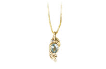 Aquamarine pendant with a diamond, textured gold necklace