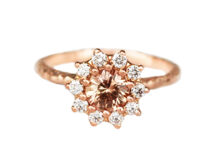 Rose gold ring with a peach sapphire and ten diamonds