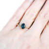 Teal oval sapphire ring with leaf prongs