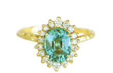 Vintage inspired hammered gold ring with an oval green sapphire and diamonds