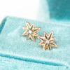 hammered gold shining star studs with diamonds, in a velvet box