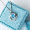 Blue topaz white gold amulet necklace