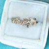 Golden wreath with green sapphires ring, in a velvet ring box