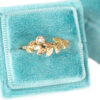 old mine cut diamond wreath ring with gold leaves in a velvet ring box