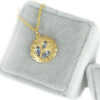 Gold medallion with three blue marquis sapphires, in a velvet box