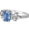 White gold ring with pale rustic blue sapphire and accent diamonds, side view