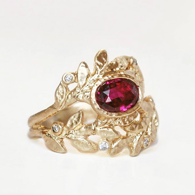 sculpted golden leaf ring with oval ruby and accent diamonds