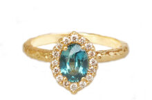 oval teal sapphire ring with a halo of diamonds