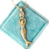 hammered gold pendant with mermaid holding a diamond, hand made necklace on a vintage velvet box