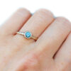 Teal sapphire textured gold ring, on hand
