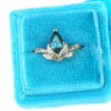 large green pear sapphire ring with golden leaves, in a vintage velvet box