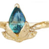 large green pear sapphire ring with golden leaves in profile