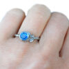 white gold leaves ring with blue sapphire on a hand