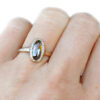 oval cognac diamond solitaire ring in textured gold, on hand
