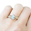 pear shape lab diamond ring with golden leaves, on hand