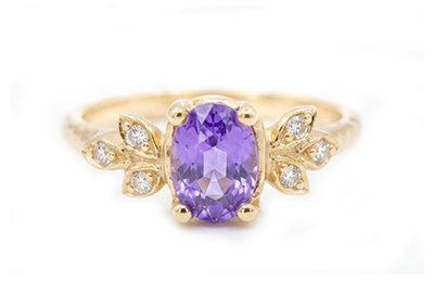 Oval purple sapphire and accent diamonds on golden leaves ring