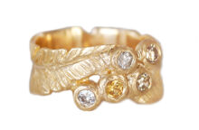 sculpted gold feather ring with diamonds and sapphire