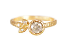 Alternative engagement ring with icy grey diamonds and three sculpted leaves with accent diamonds