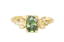 Textured gold ring with a Forest green oval sapphire and six diamonds in golden leaves